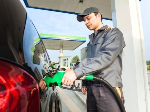 Petrol Station Attendant Filling a Tank