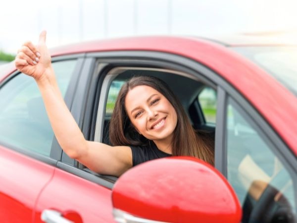 Woman Driving a Red Car