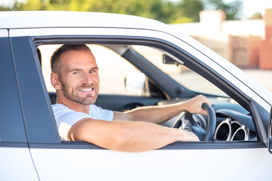 Man Driving a White Car