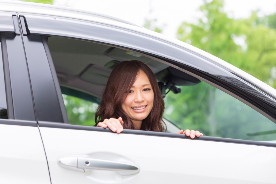 Woman Driving a Silver Car