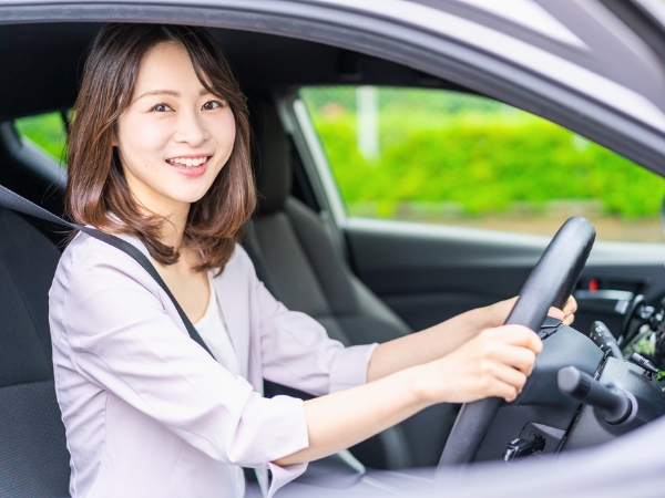 Woman Driving a Silver Car