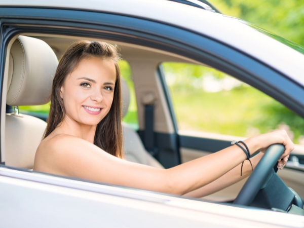 Woman Driving a Silver Car