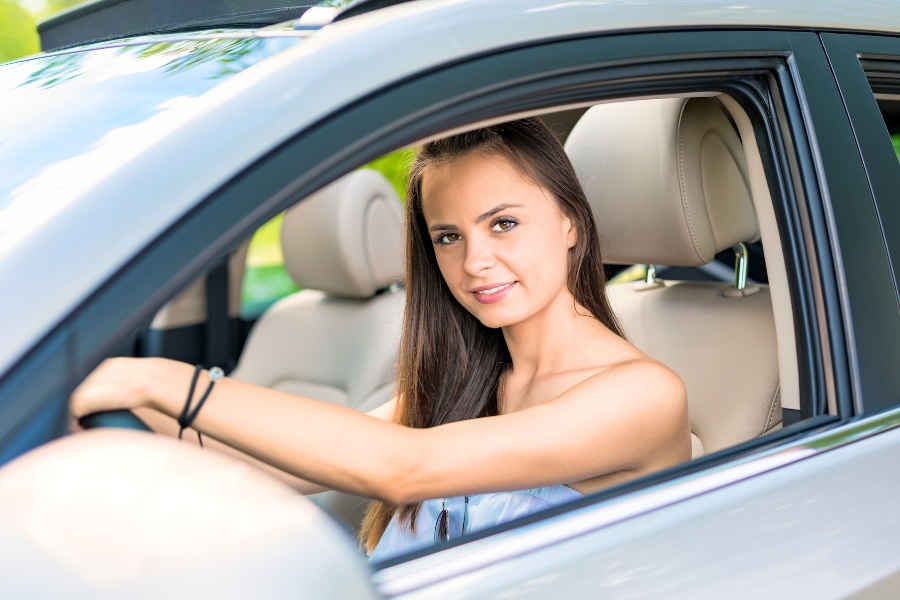 Woman Driving a Silver Car